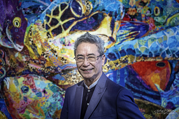 Danny Amazonas stands in front of Abyss, one of his large works measuring 118” x 68” (300cm x 176cm). Photo by Alex Labry.