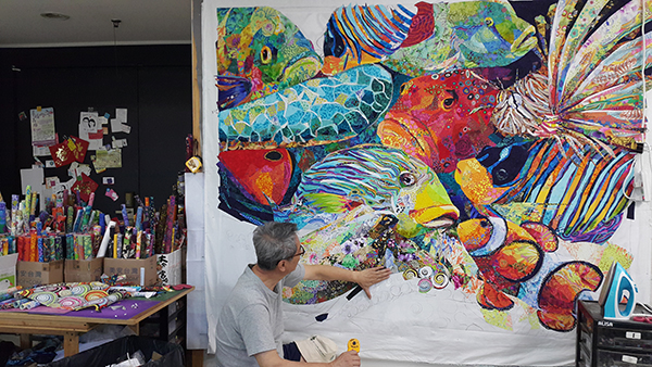 Once the fabrics are prepared, Danny sketches the image he wants to create onto a base fabric on a design wall in his studio in Kaohsiung, Taiwan. Photo courtesy of Danny Amazonas.