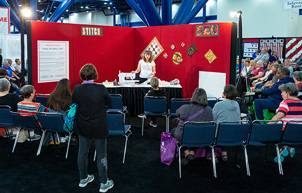 Teresa Coates demonstrates in the “Stitch/Sew” area of Open Studios at Houston Festival