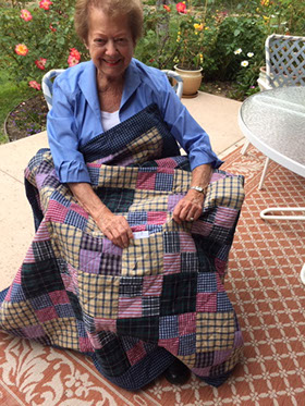 Pat Nickols with a memory quilt she made from shirts worn by her late brother as a gift for her sister-in-law. Photo courtesy of Pat Nickols.