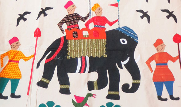 Traditional Gujarat appliqué might include colorful figures of people and animals stitched on a white ground and reflecting a distinctive cultural heritage.